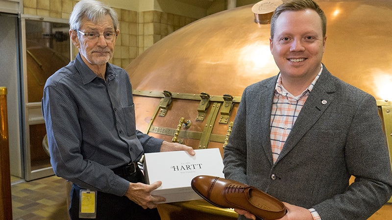 Owner of Moosehead, Derek Oland (left) holds a box of Hartt Shoes with Hartt CEO, Andrew Bedford.