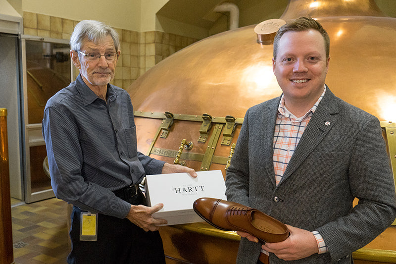 Owner of Moosehead, Derek Oland (left) holds a box of Hartt Shoes with Hartt CEO, Andrew Bedford.