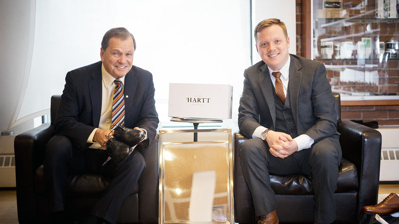 Frank McKenna (left) poses for a photo with, CEO of the Hartt Shoe Company Andrew Bedford.