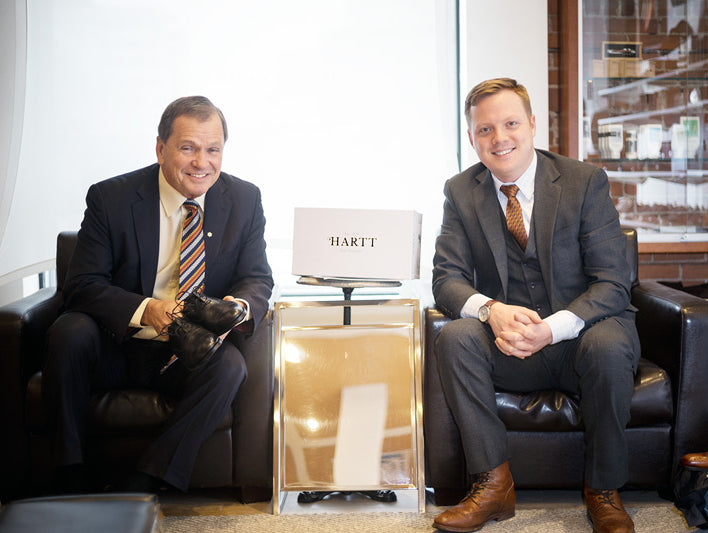 Frank McKenna (left) poses for a photo with, CEO of the Hartt Shoe Company Andrew Bedford.