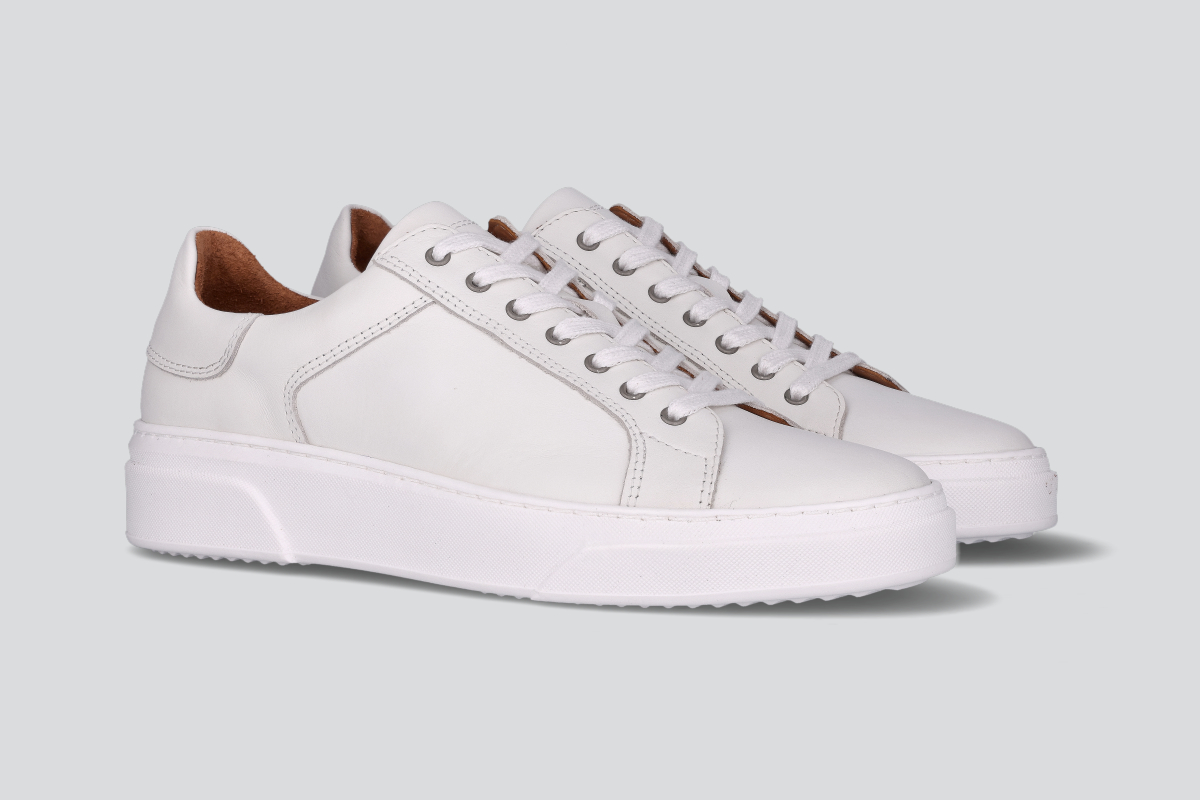 A pair of white men's low top sneaker from the Hartt Shoe Company