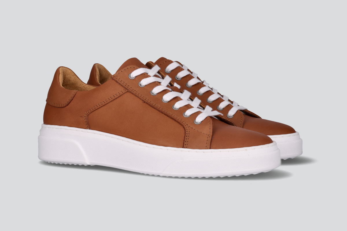 A pair of cognac men's low top sneaker from the Hartt Shoe Company
