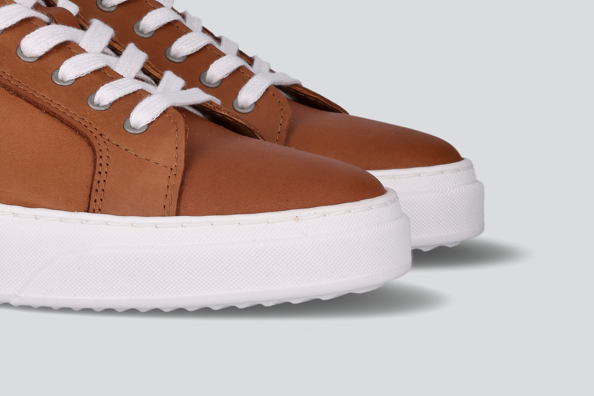 The toes of cognac men's low top sneaker from the Hartt Shoe Company