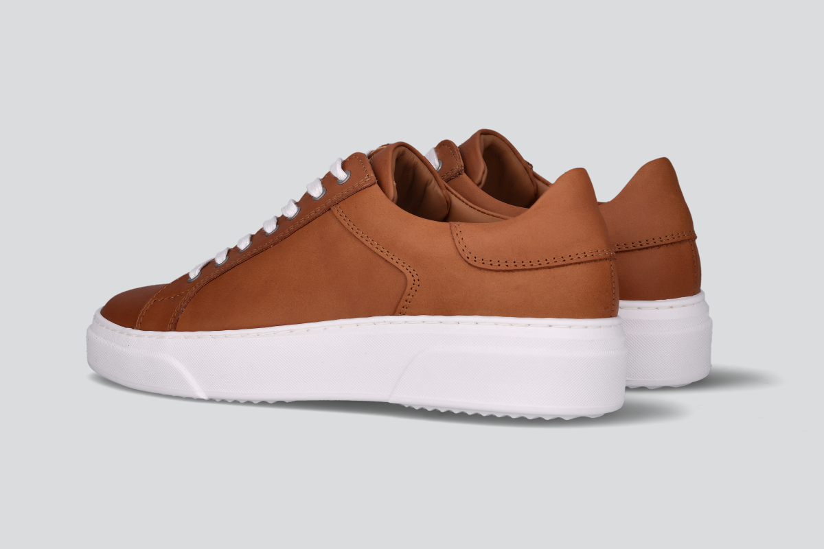 A pair of cognac men's low top sneaker from the Hartt Shoe Company