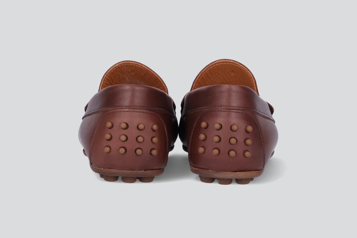 The heels a pair of dark brown men's miles driver loafers from the Hartt Shoe Company