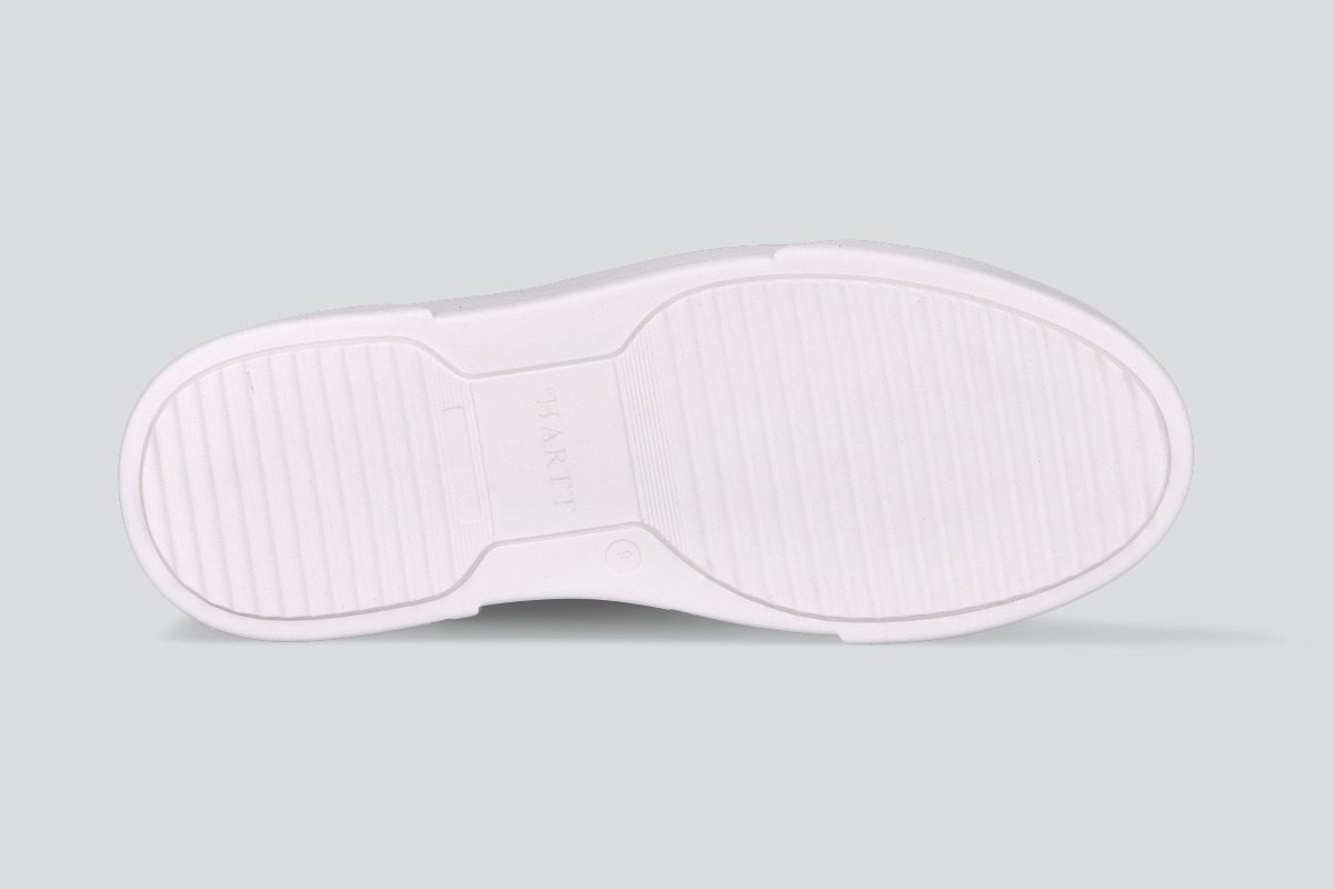 The sole of a navy men's low top sneaker from the Hartt Shoe Company