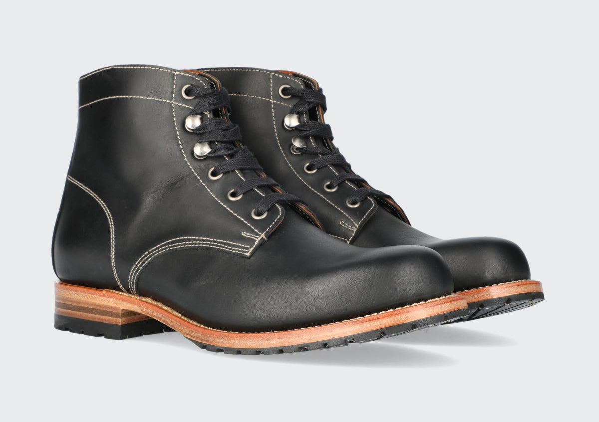 A pair of men's black leather boots made by the Hartt Shoe Company