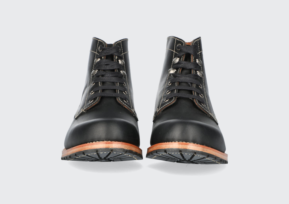 The front of a pair of black leather boots from the Hartt Shoe Comapany.