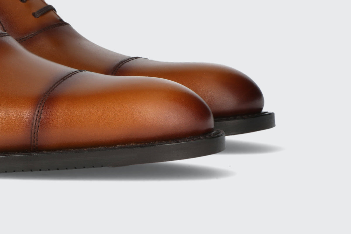 The toes of a pair of men's leather dress shoes from the Hartt Shoe Company