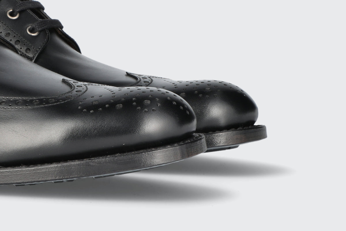 The toes of a pair of black leather dress boots from the Hartt Shoe Company