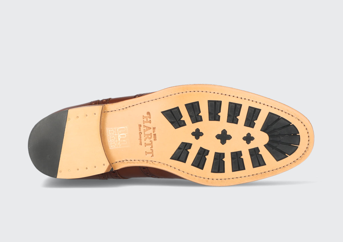 The soles of a pair of goodyear welted dress boots from the Hartt Shoe Company