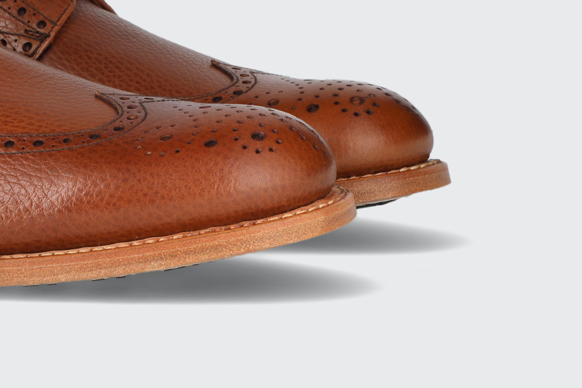 The toes of a pair of brown dress boots from the Hartt Shoe company