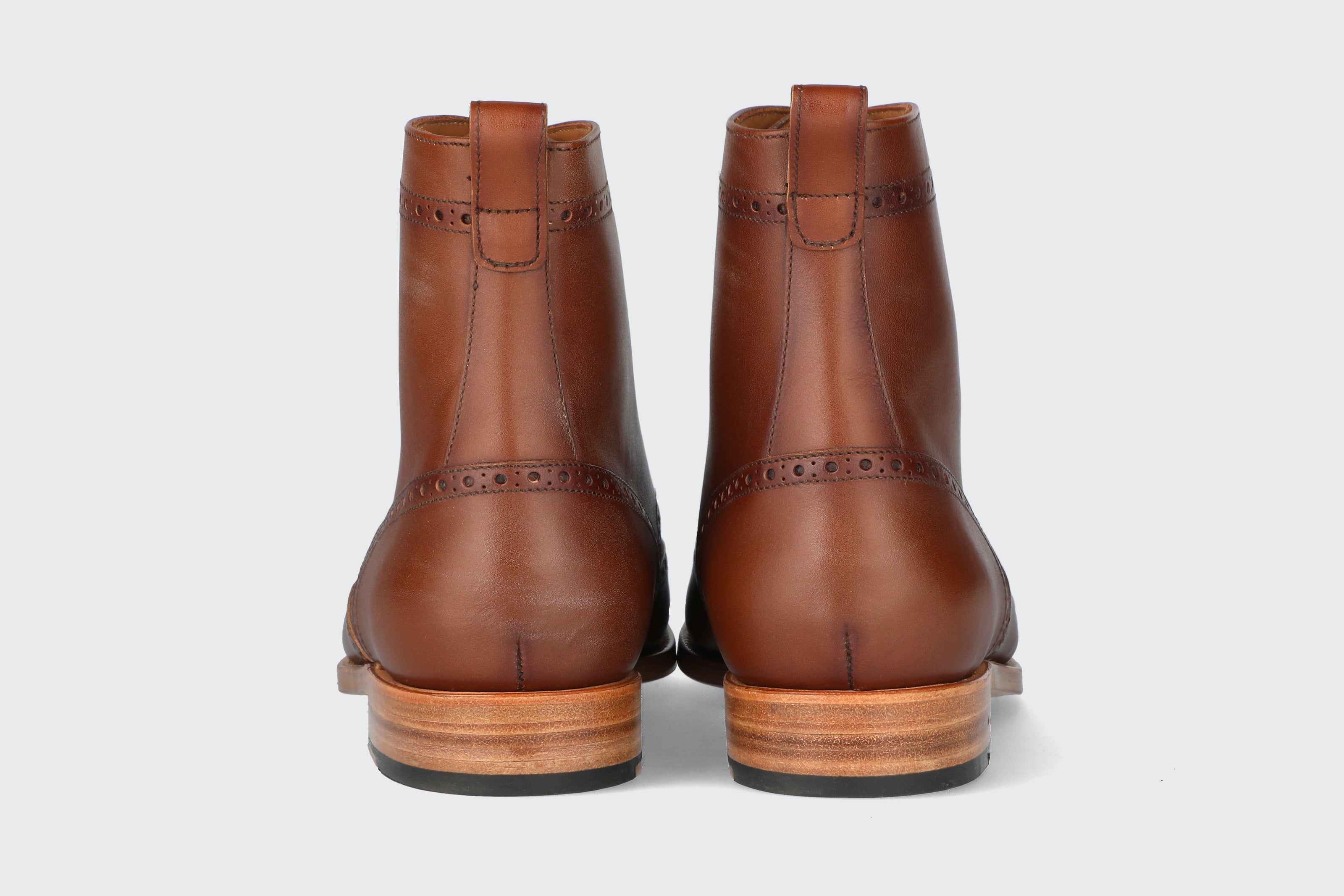 The heels of a pair of brown leather dress boots from the Hartt Shoe company