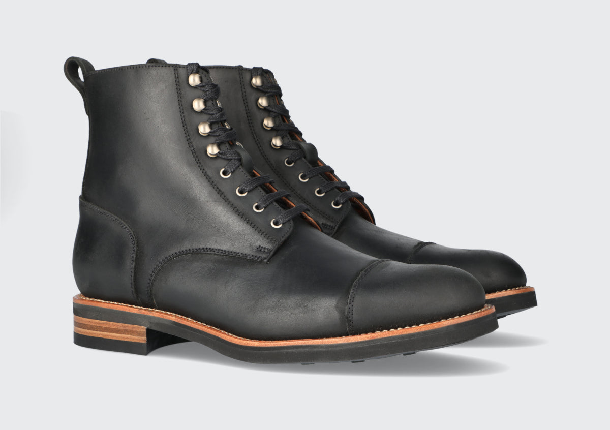 A pair of black leather brewers boots from the Hartt Shoe company