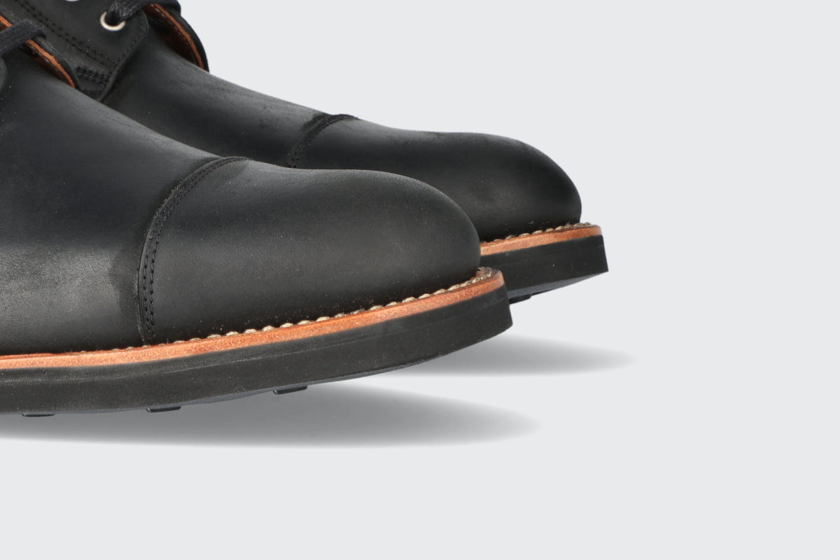 The toes of a pair of black leather boots from the Hartt shoe Company