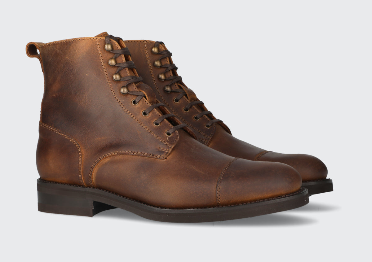 A pair of men's tan leather boots from the Hartt Shoe company