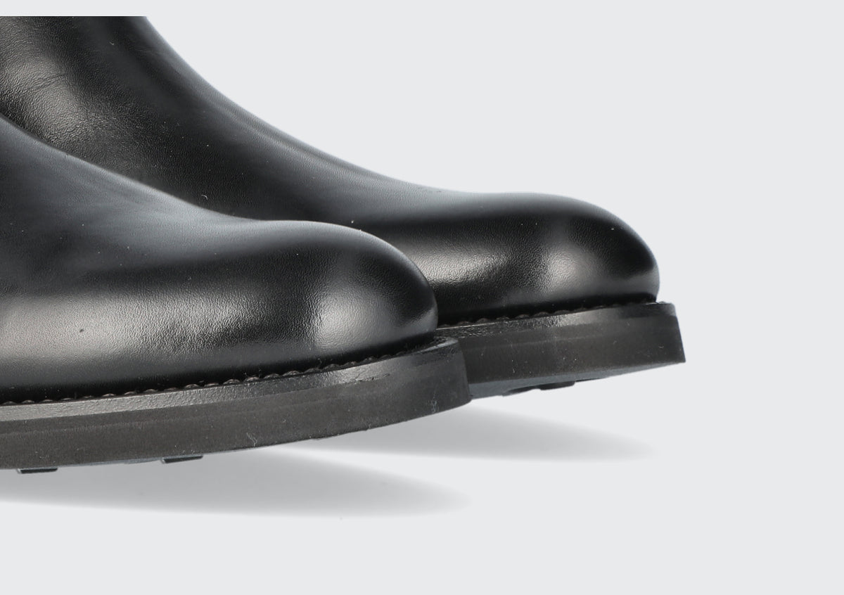 The toes of a pair of black chelsea boots from the Hartt Shoe company