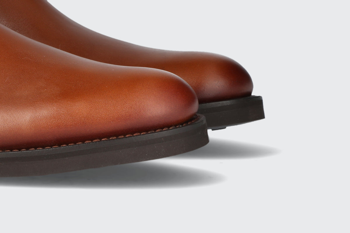 The toes of a pair of brown chelsea boots from the Hartt Shoe Company