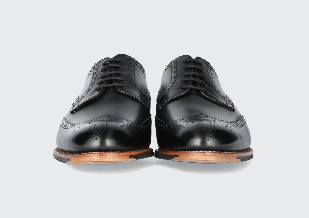 The front of a pair of black leather derbies from the Hartt Shoe Company
