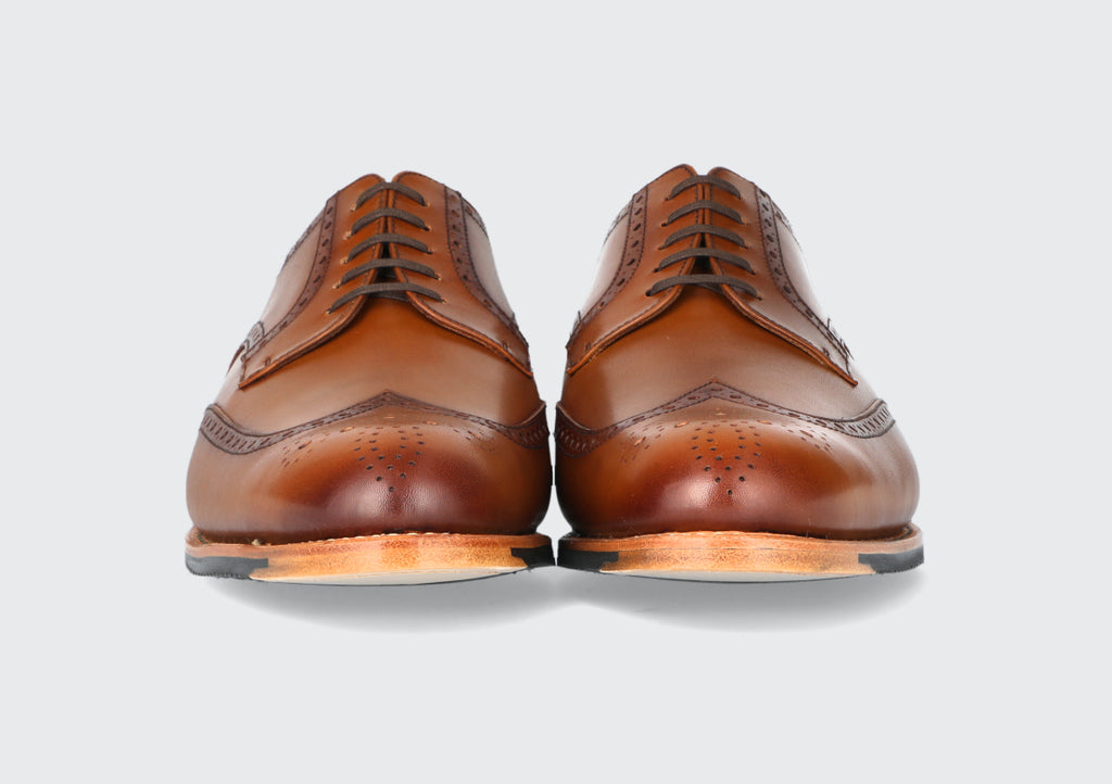 The front of a pair of brown derby dress shoes from the Hartt Shoe Company