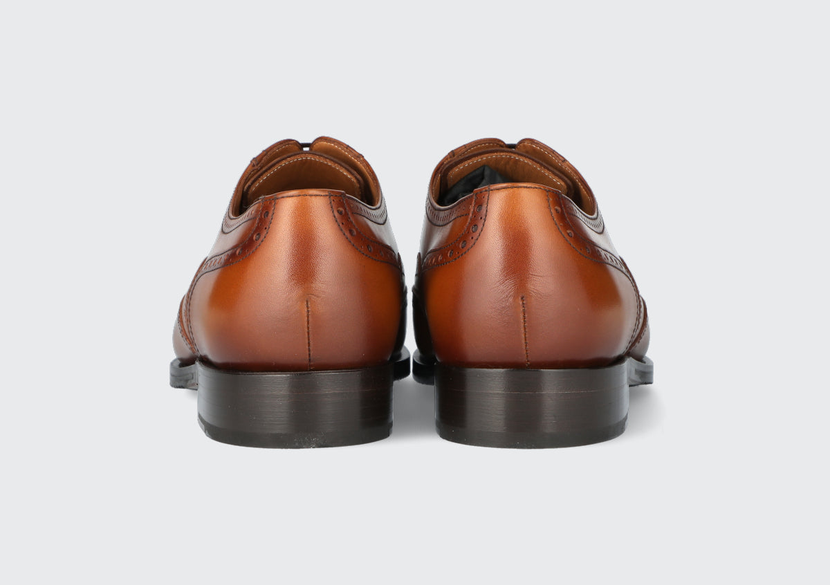 The heels of pair of brown leather dress shoe from the Hartt Shoe Company