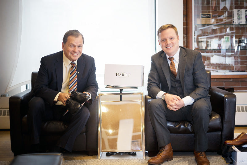 Frank McKenna (left) poses for a photo with, CEO of the Hartt Shoe Company Andrew Bedford. 