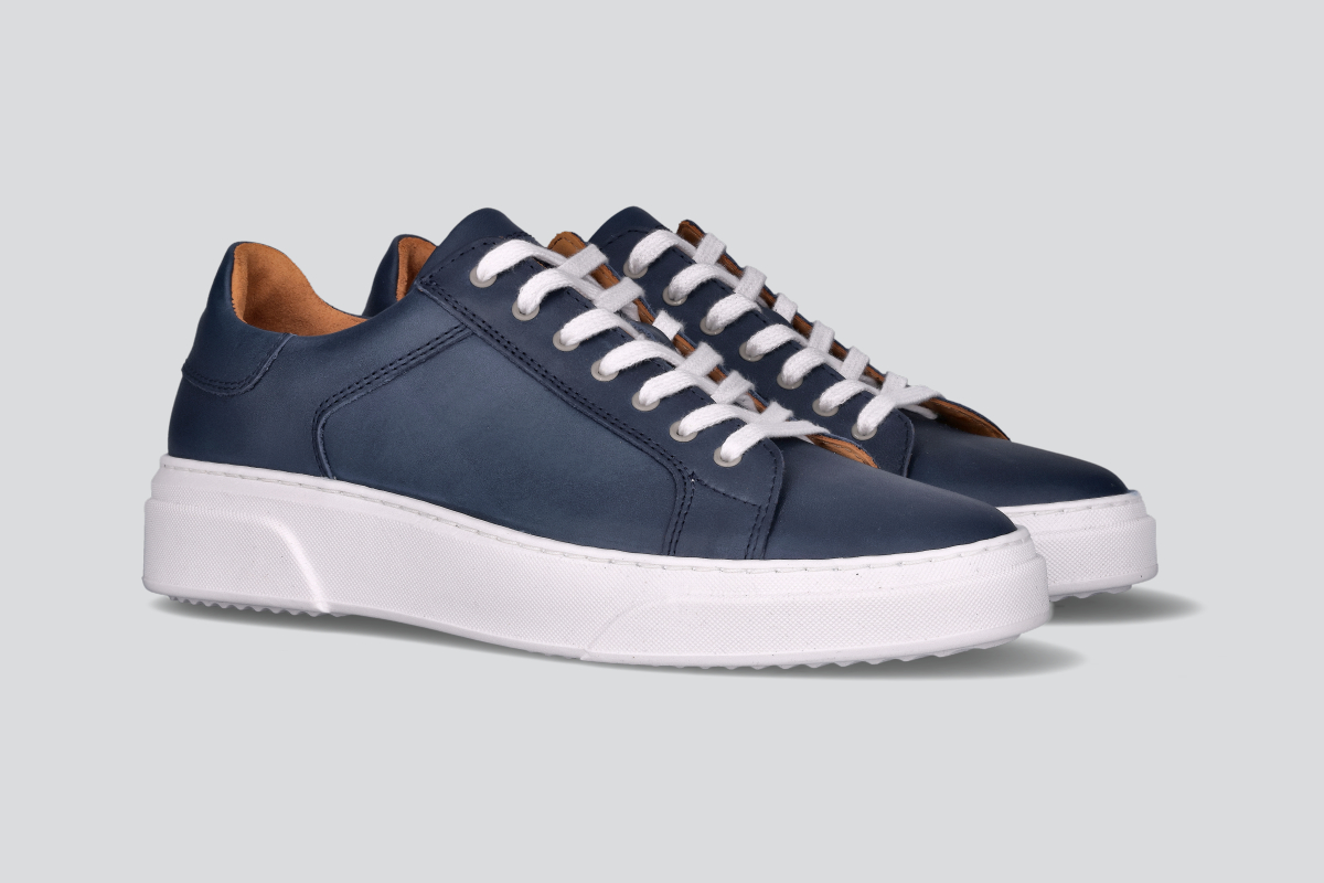 A pair of navy men's low top sneaker from the Hartt Shoe Company