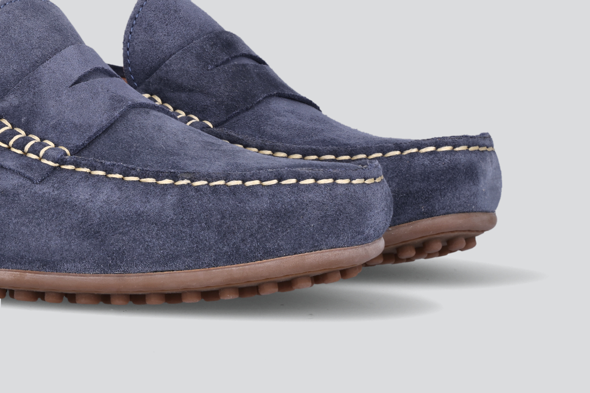 The toes of navy men's miles driver loafers from the Hartt Shoe Company