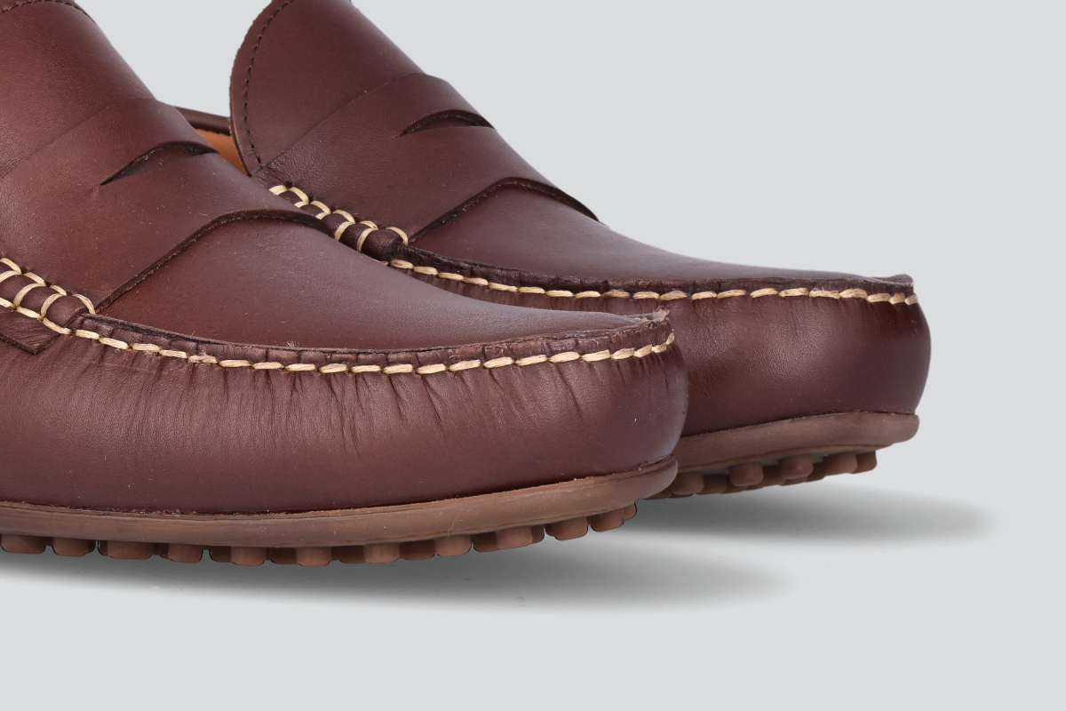 The toes of dark brown men's miles driver loafers from the Hartt Shoe Company