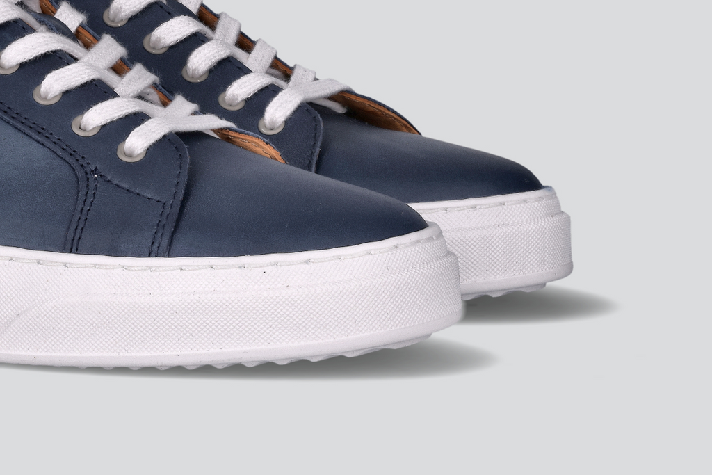 The toes of navy men's low top sneaker from the Hartt Shoe Company