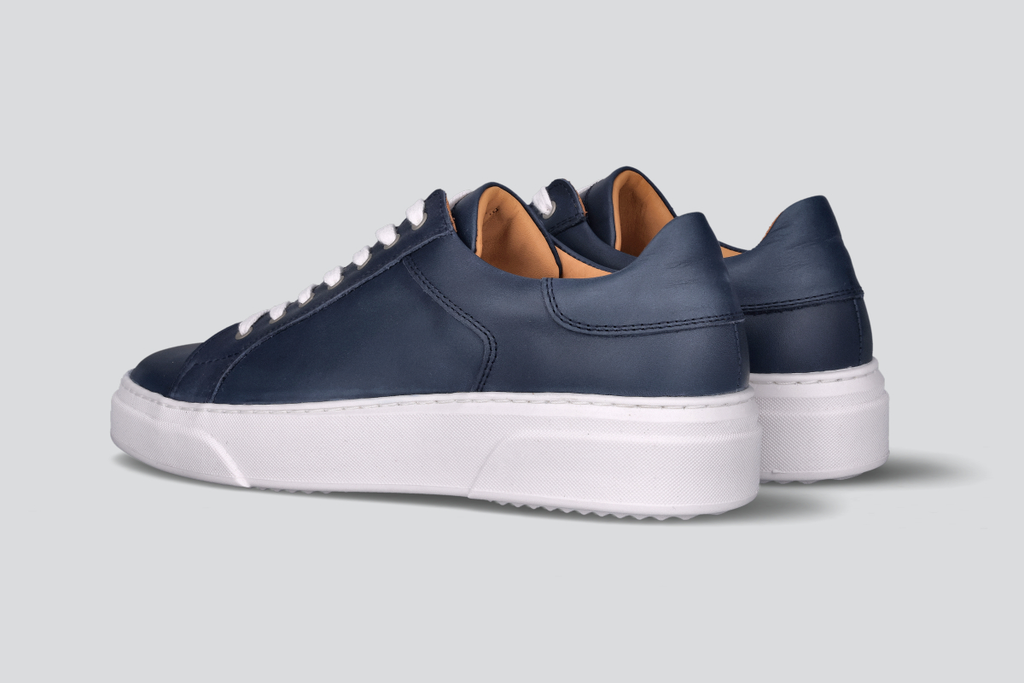 A pair of navy men's low top sneaker from the Hartt Shoe Company