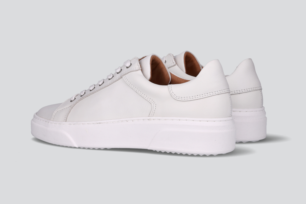 A pair of white men's low top sneaker from the Hartt Shoe Company