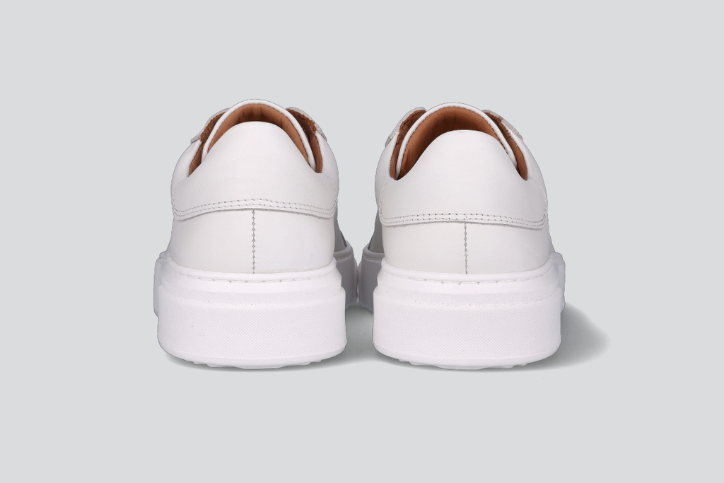 The heels of a pair of white men's low top sneaker from the Hartt Shoe Company