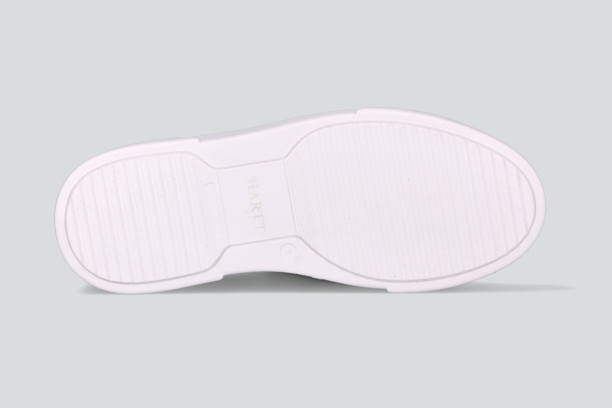 The sole of a white men's low top sneaker from the Hartt Shoe Company