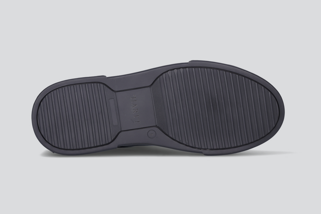 The sole of a black men's low top sneaker from the Hartt Shoe Company