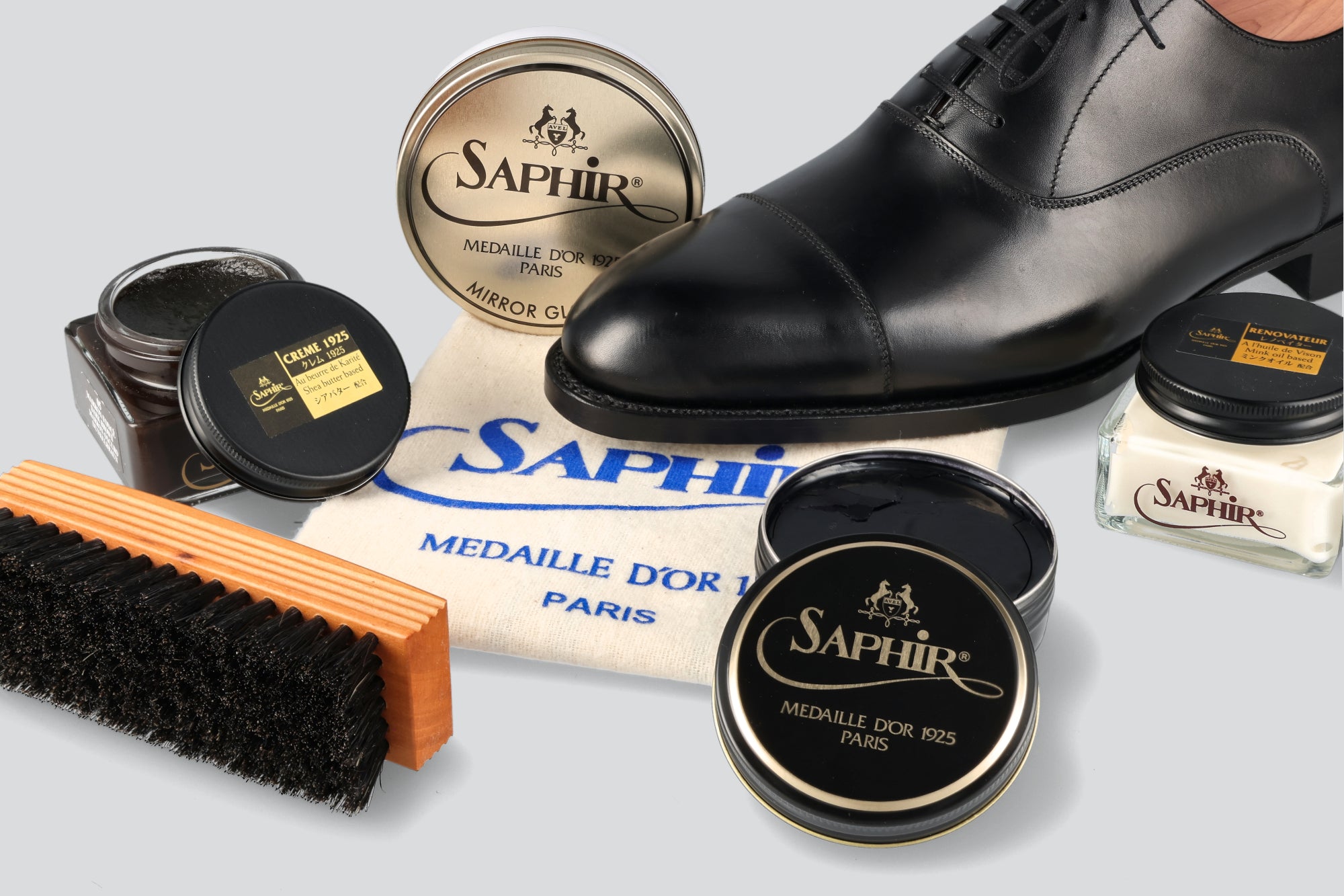 A saphir shoe polish kit with a black dress shoe