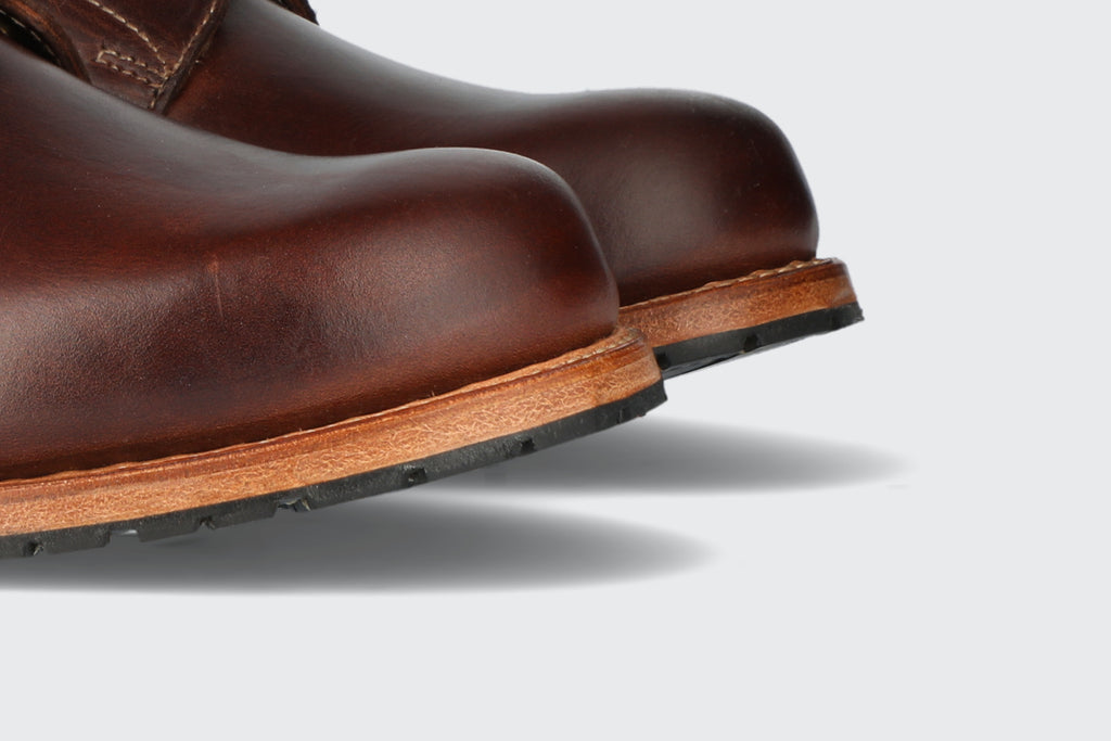 The toes of a pair of oxblood leather boots