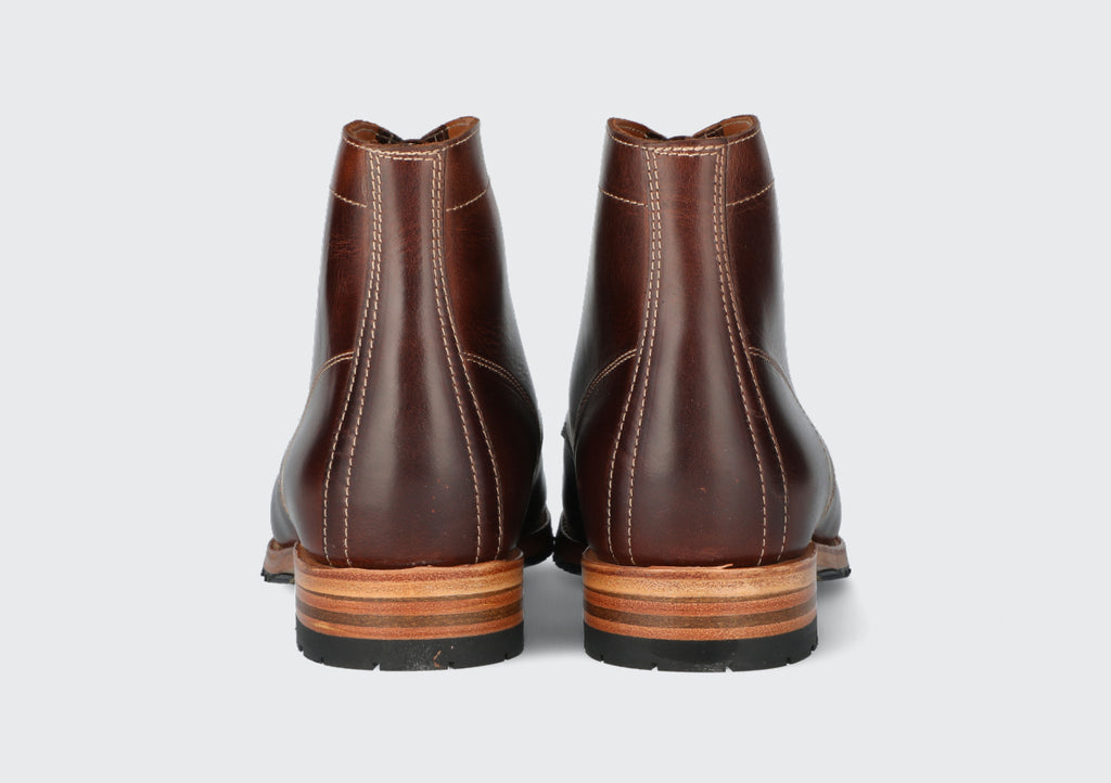 The heels of a pair of men's oxblood leather boots