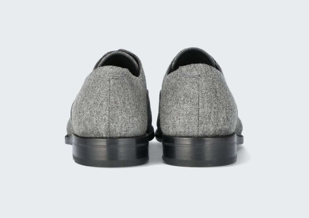The heels of a pair of men's grey dress shoes from the Hartt Shoe Company