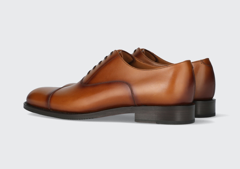 A brown pair of men's leather dress shoes made by the Hartt Shoe Company