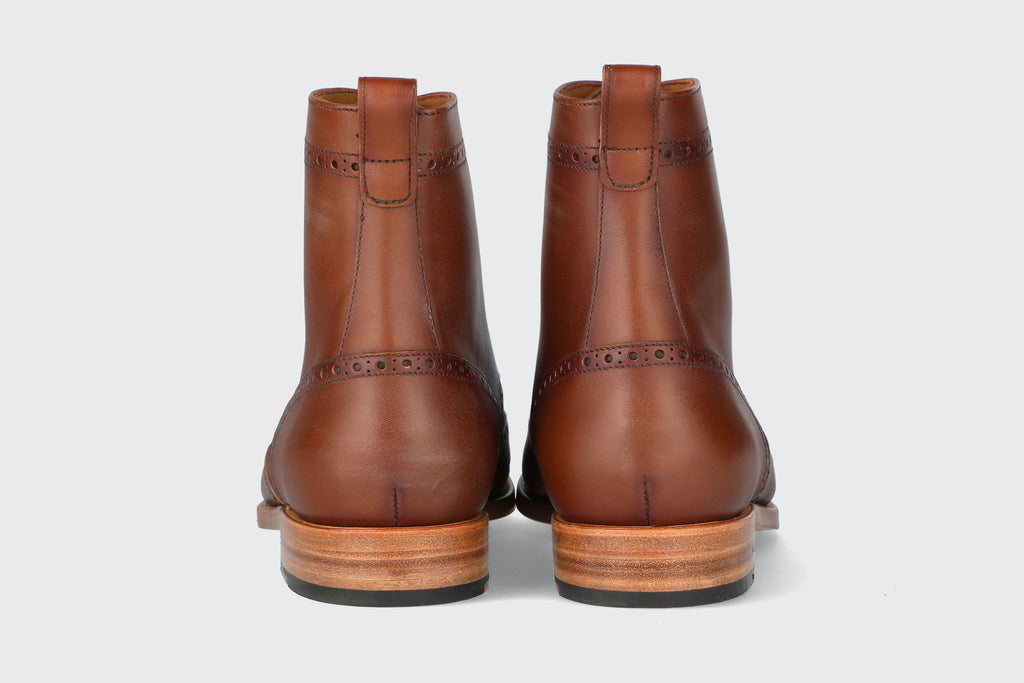 The heels of a pair of brown leather dress boots from the Hartt Shoe company