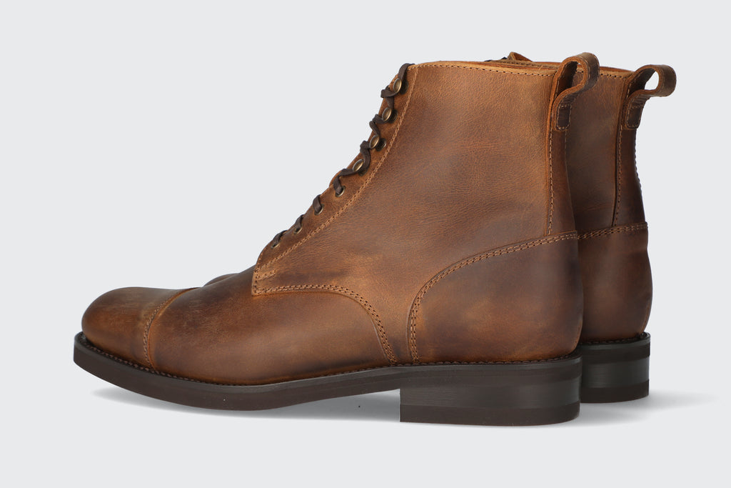 A pair of men's tan leather boots from the Hartt Shoe company