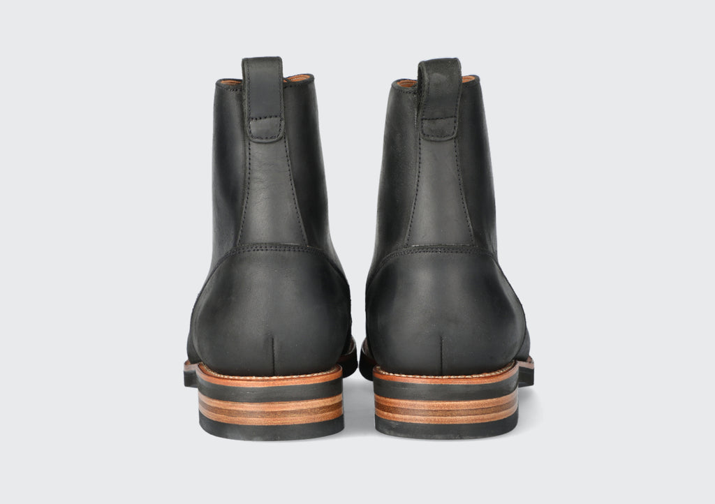 The heels of a pair of black brewers boots from the Hartt Shoe Company