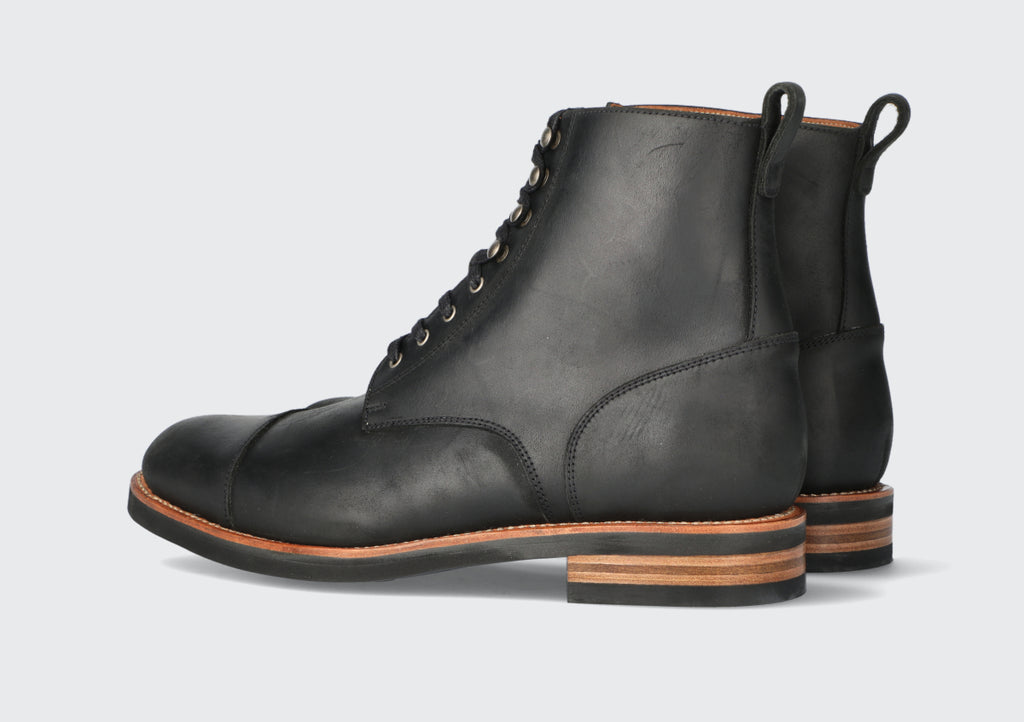 A pair of men's black brewers boots from the Hartt Shoe Company