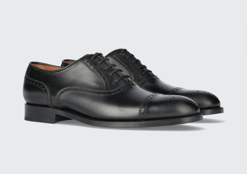 A pair of men's black leather brogues dress shoes from the Hartt Shoe Company