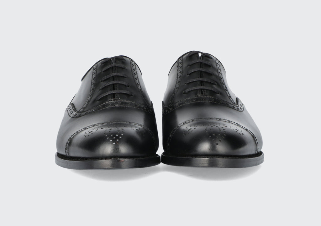 The front of a pair of men's black dress shoes from the Hartt Shoe Company