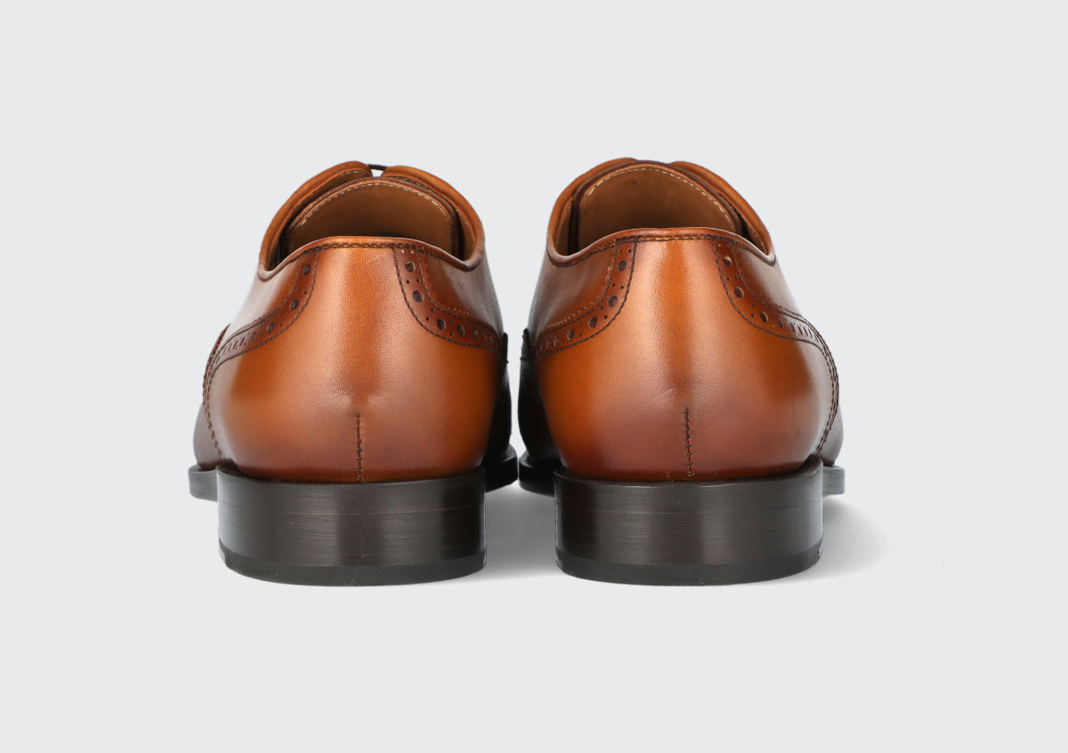 The heels of a pair of brown leather dress shoes from the Hartt Shoe company