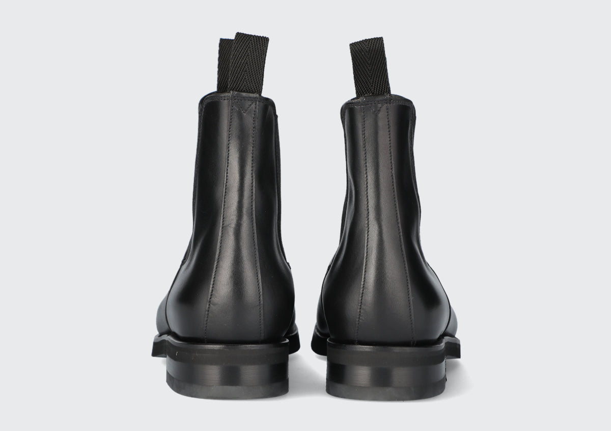 The heels of a pair of black chelsea boots from the Hartt Shoe company