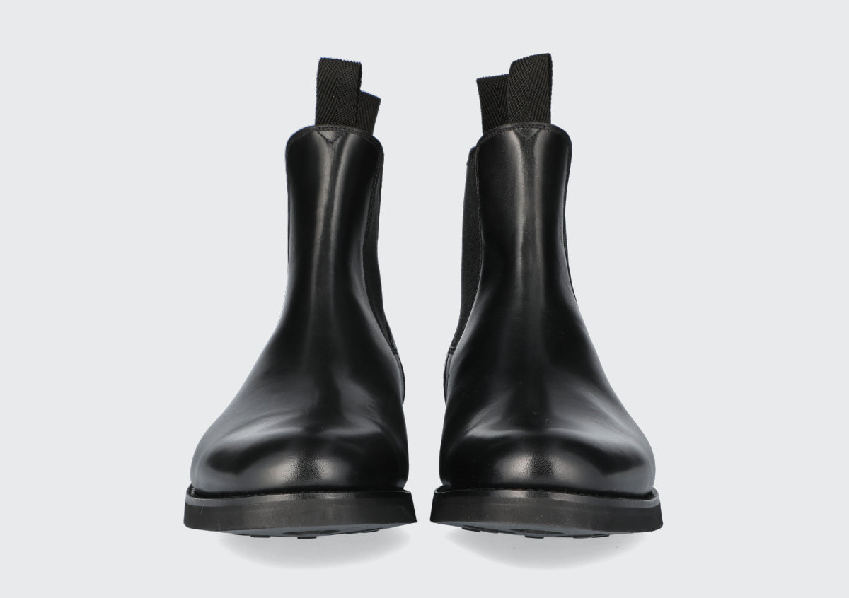 The front of pair of black chelsea boots from the Hartt Shoe Company