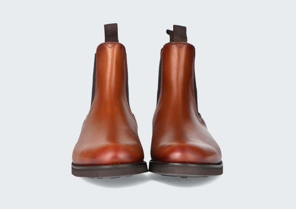 The front of a pair of brown leather chelsea boots from the Hartt Shoe company